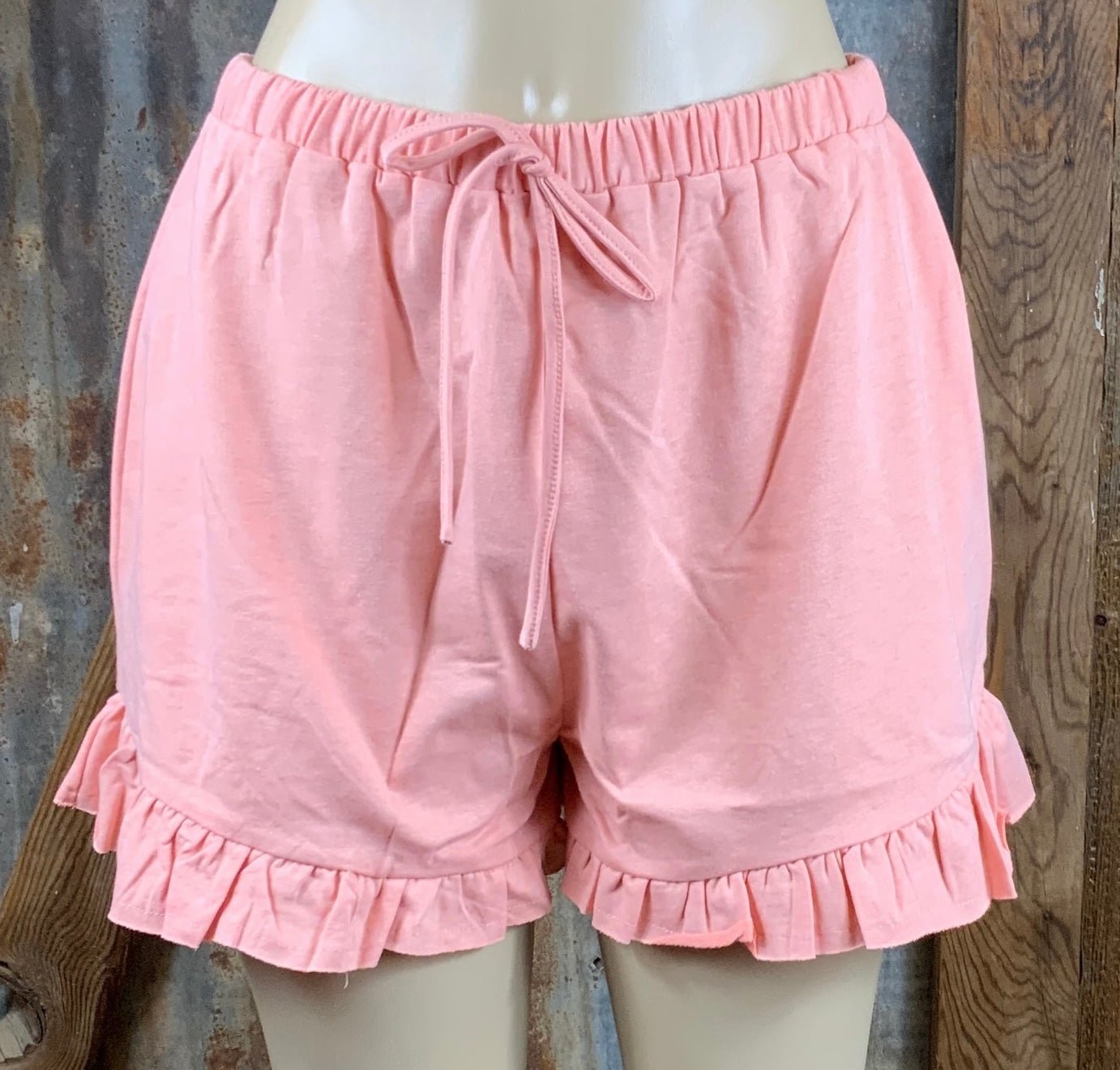 Main Strip brand. Drawstring tie waisted shorts with ruffled bottom hem. Loose fit. Available in Dusty Rose and Black.