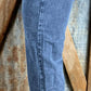 Vintage-inspired high waisted jeans with asymmetrical button closure. Straight legs are slightly tapered at the ankles.