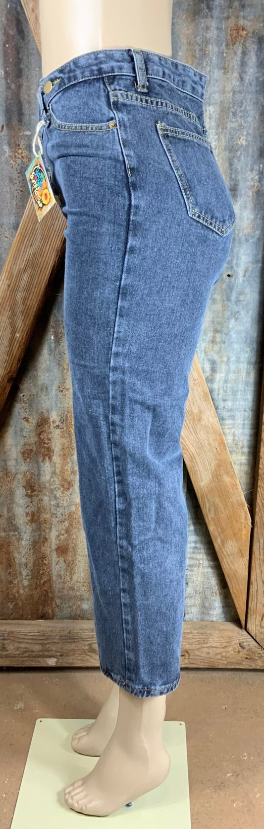 Vintage-inspired high waisted jeans with asymmetrical button closure. Straight legs are slightly tapered at the ankles.