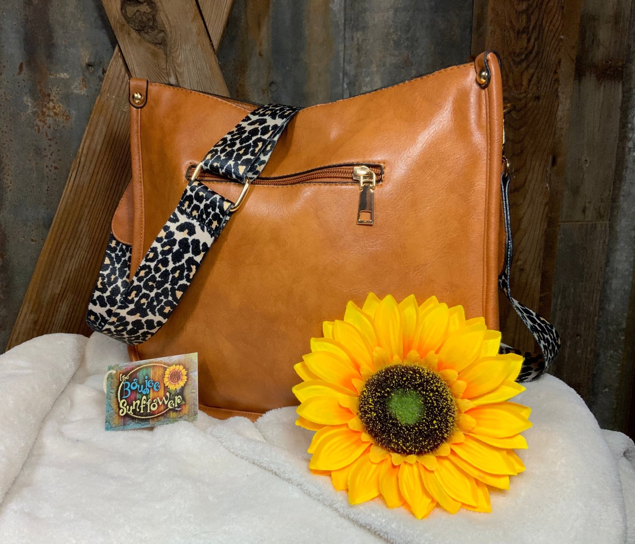 LivFoxy brand. Tan color with leopard print strap Sydney crossbody. Outer open pocket and zippered pouch. $35