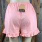 Main Strip brand. Drawstring tie waisted shorts with ruffled bottom hem. Loose fit. Available in Dusty Rose and Black.