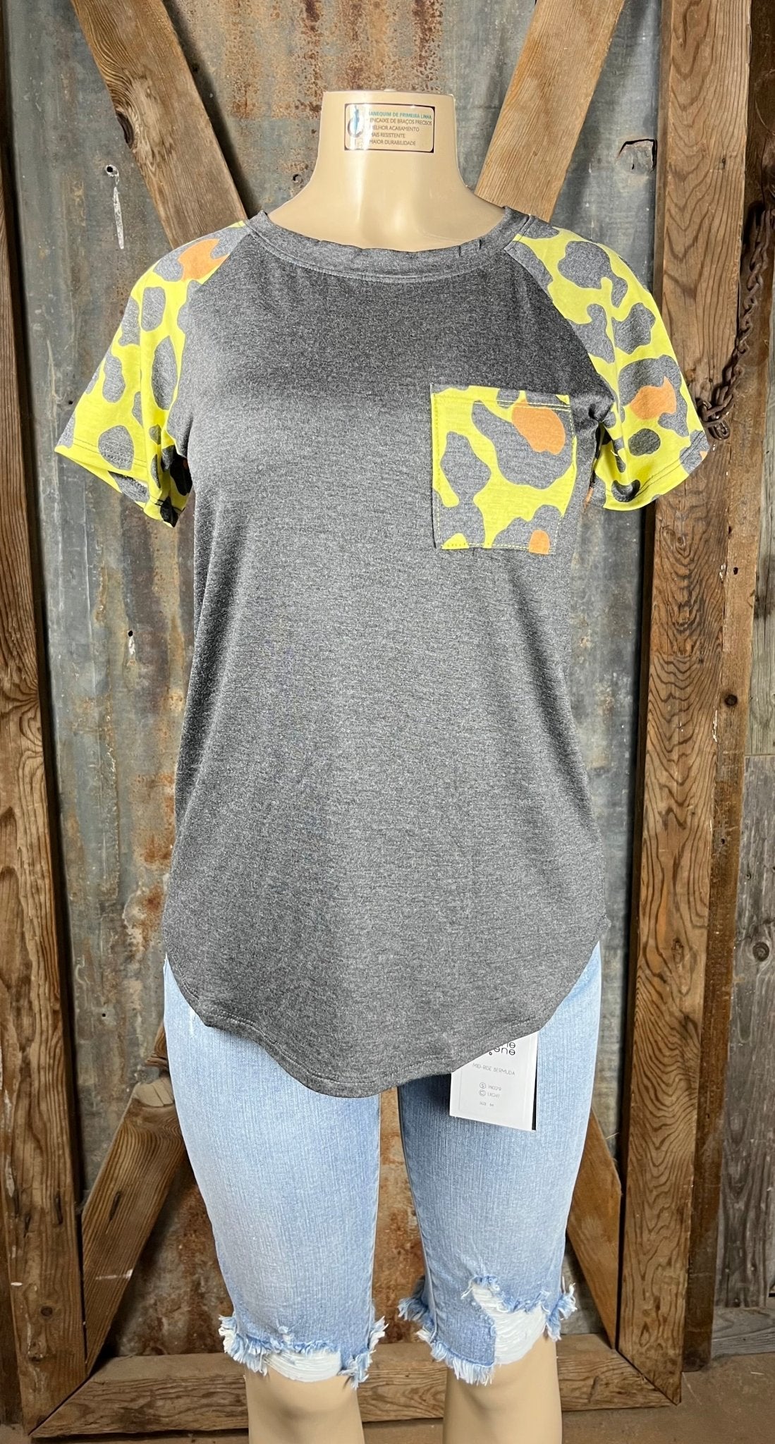 Celeste Clothing brand. Charcoal gray bodice with multicolored leopard short sleeves in yellow, orange and gray top.