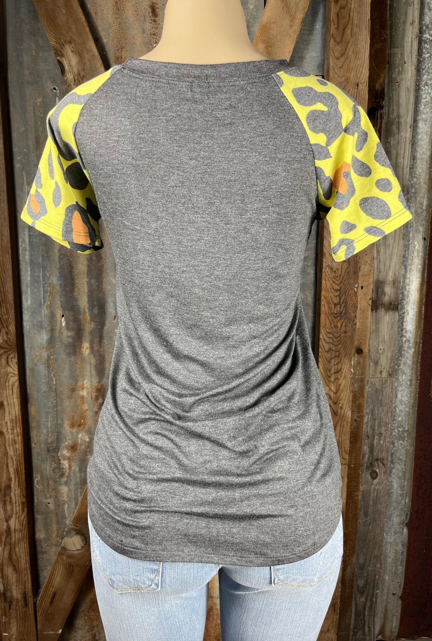 Celeste Clothing brand. Charcoal gray bodice with multicolored leopard short sleeves in yellow, orange and gray top.