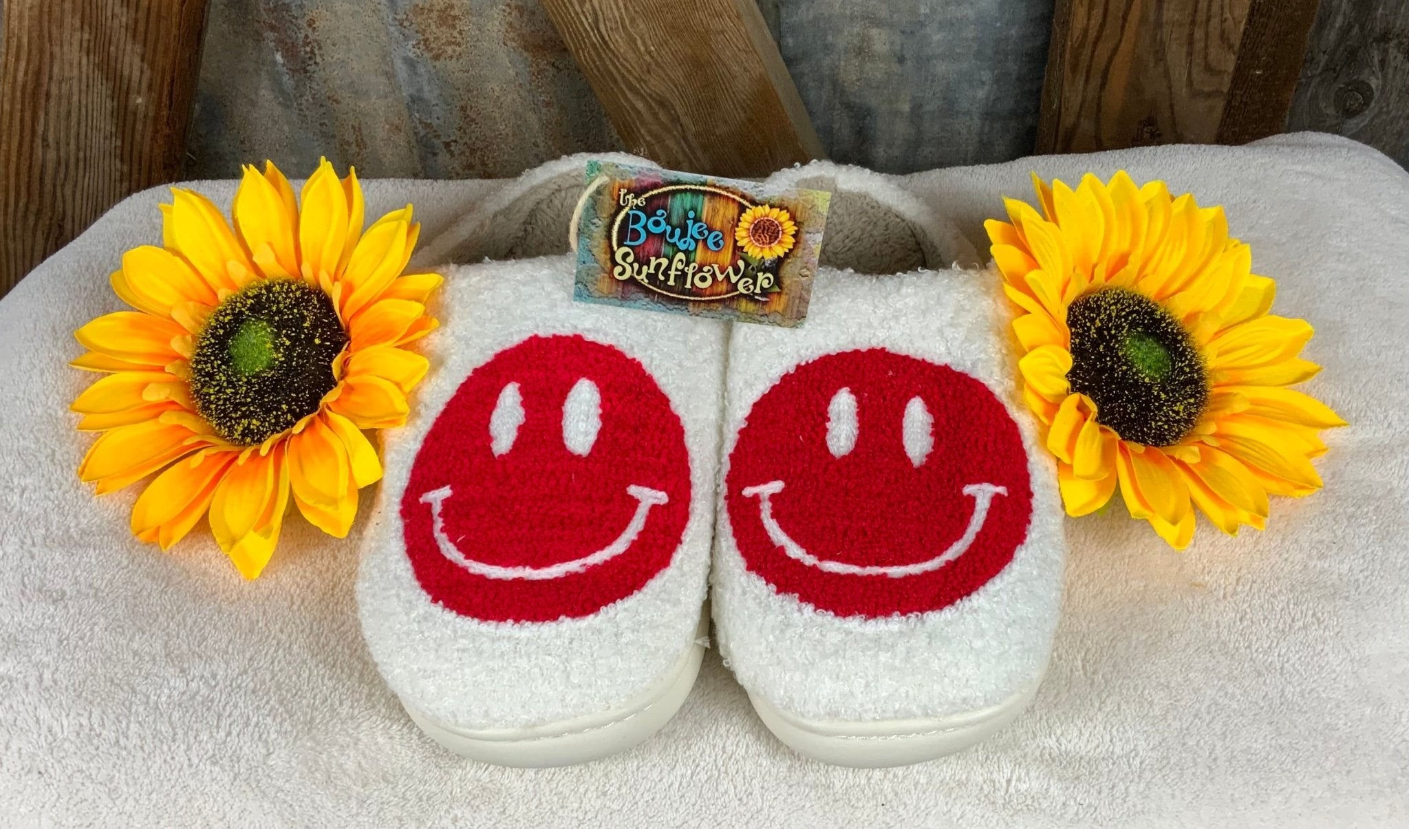 White fluffy exterior with red happy face, beige soft interior with white hard rubber sole for indoor/outdoor wear.