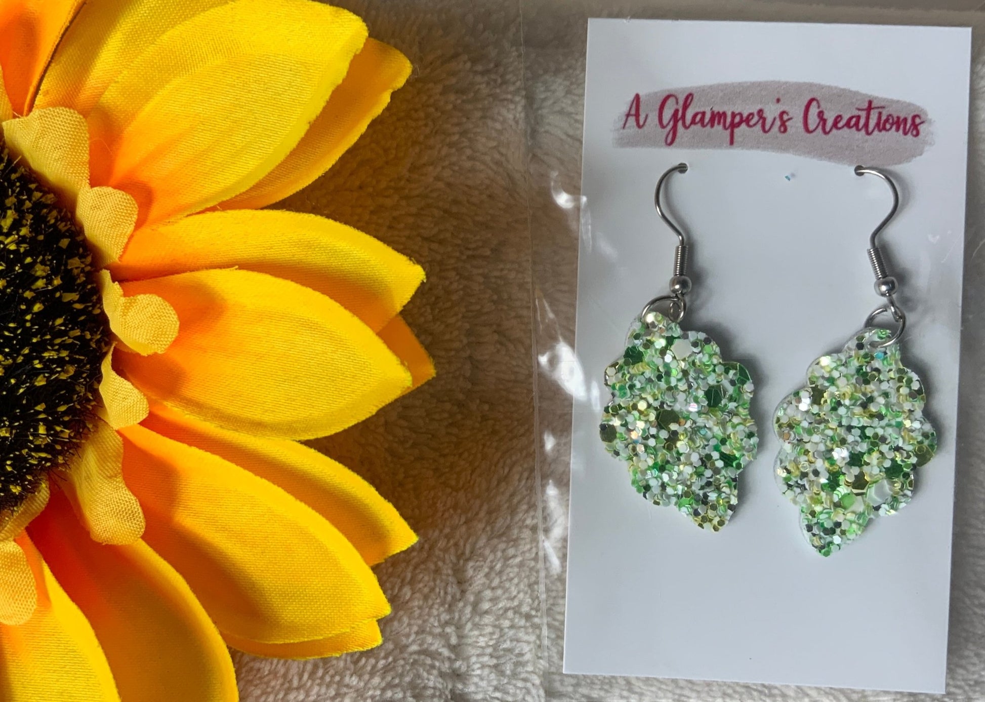 A Glamper's Creation, LLC brand. Scalloped silver dangle green, white and gold glitter earrings. $8