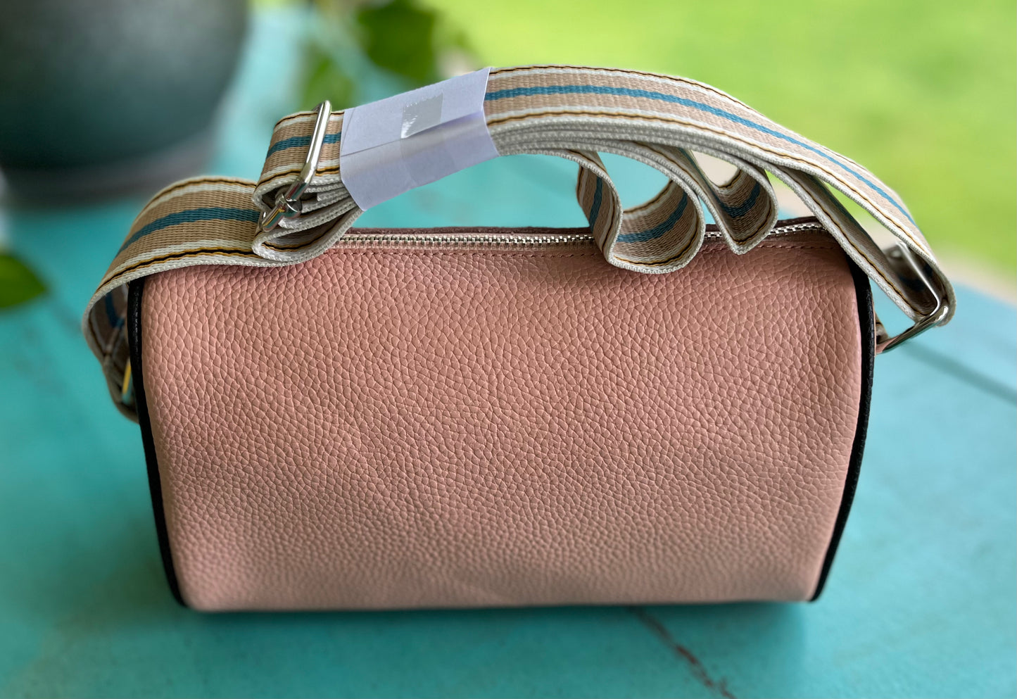 Miss Sparkling brand. This blush pink crossbody has multicolored strap. 9" x 4" x 6". $28