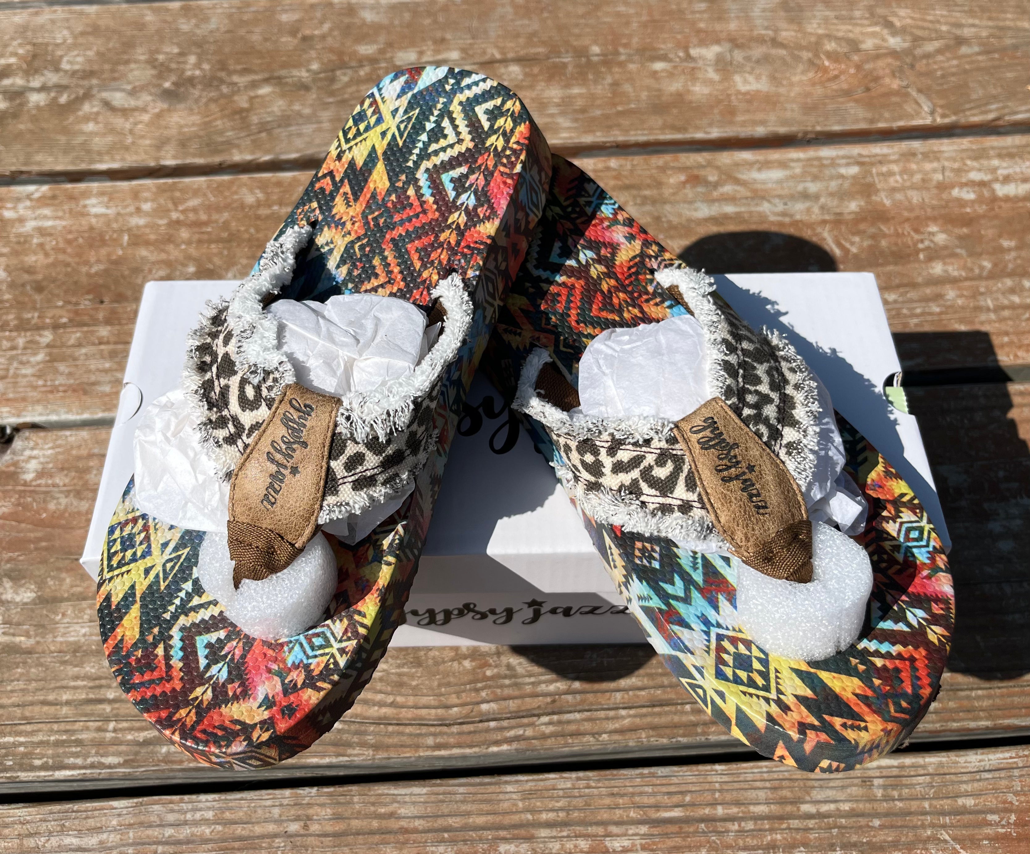 Gypsy Jazz brand. Tallulah flip flops feature an Aztec and multicolored rubber sole with leopard frayed straps. Whole/Half sizes: 6-9.5. Whole sizes only: 10, 11. $18