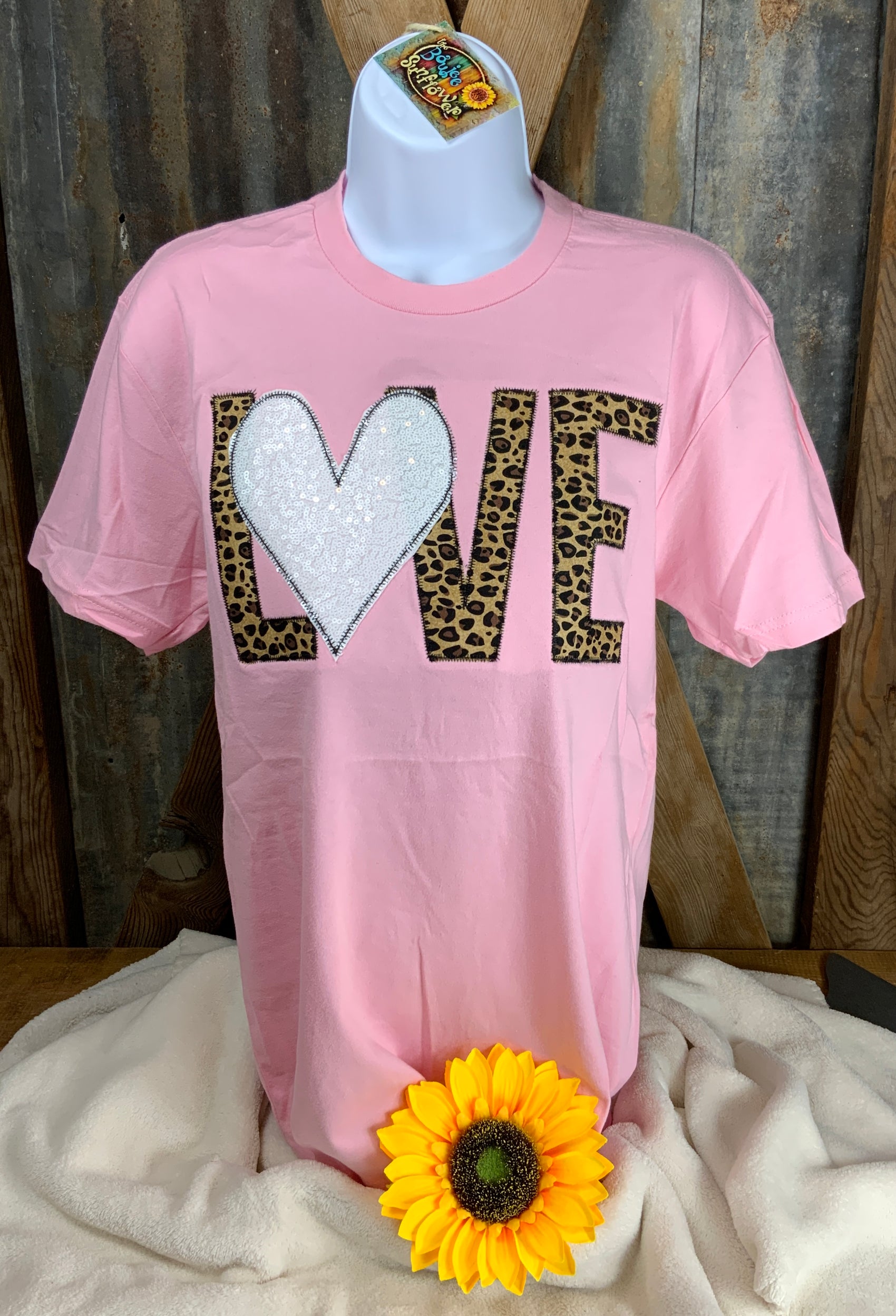 Shop Southern Belle brand. Valentine tee with leopard letters in Light Pink or Black tee with either a white or red sequined heart. S, M, L. $20