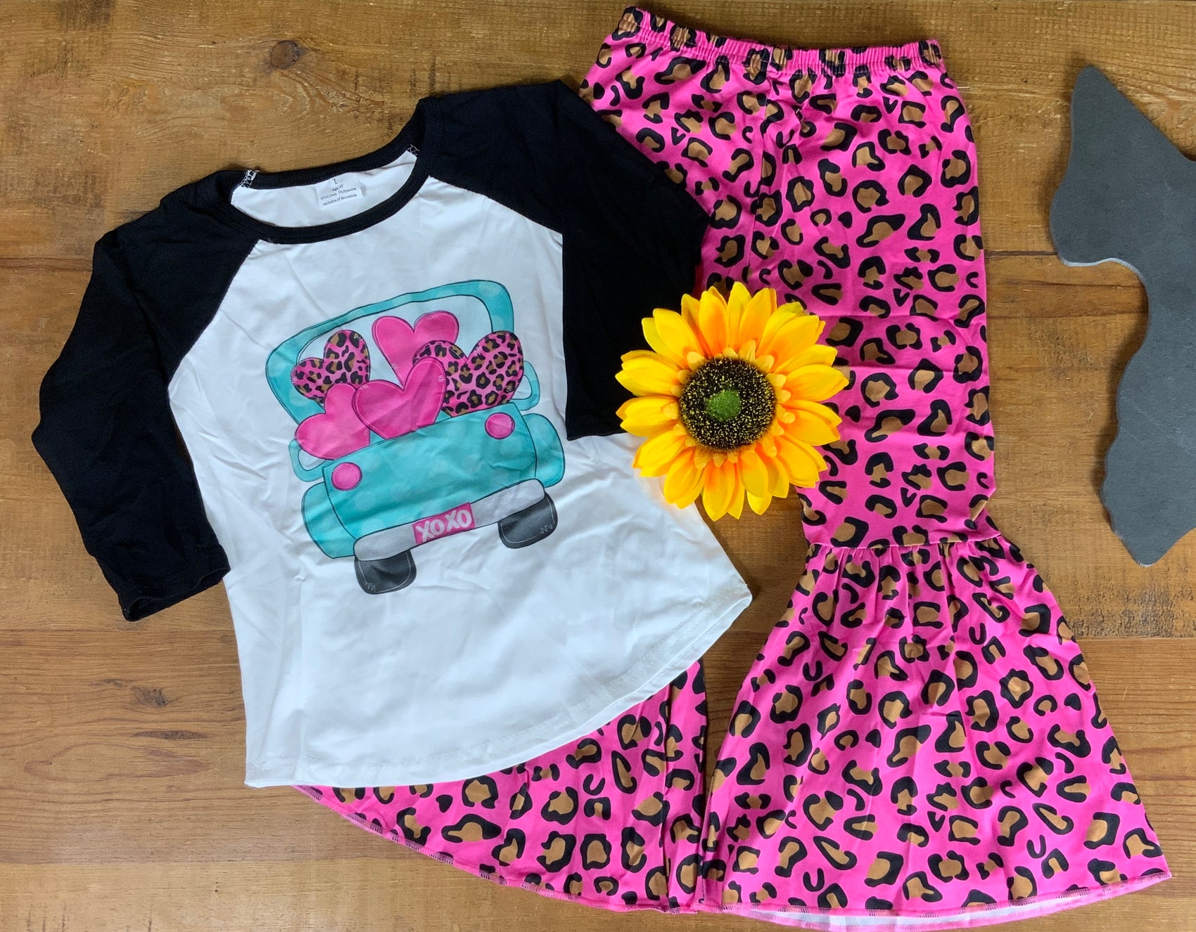 Yawoo Garments brand. Toddler. Black and white baseball top with 3/4 sleeves and truck with hearts graphic and hot pink elasticized waist bell bottom leggings with leopard print design. 4T, 5-6T, 6-7T. $15T