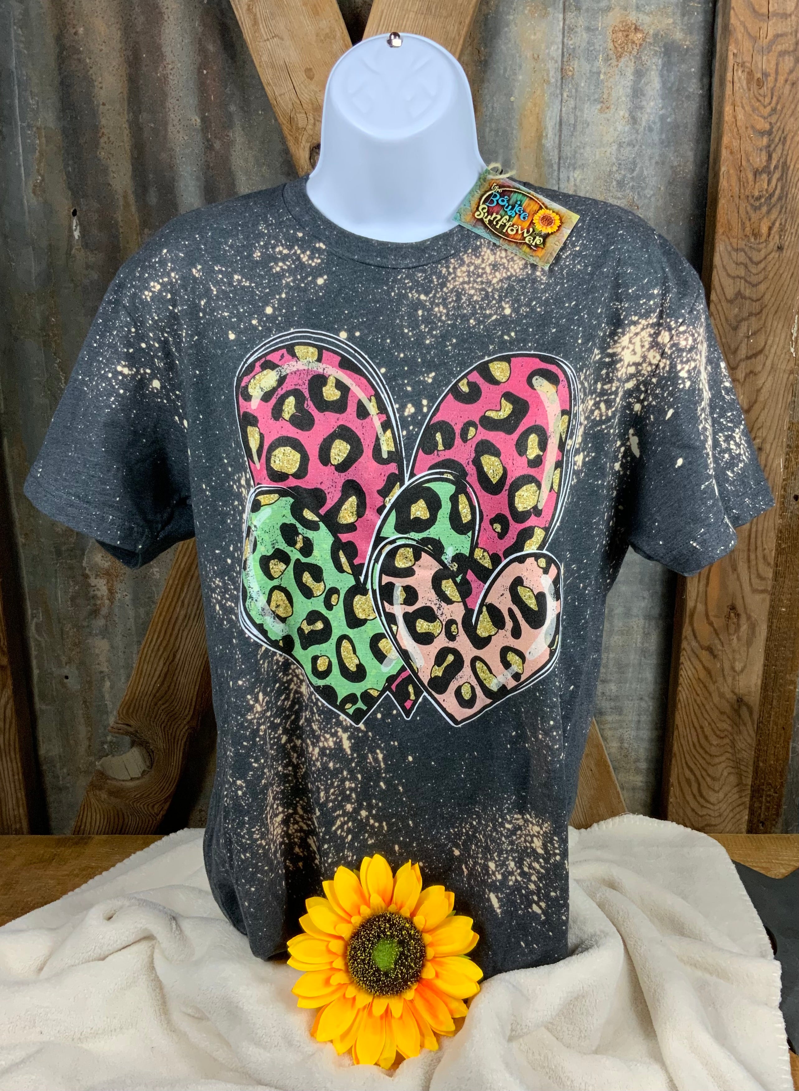 The Way Down South brand. Charcoal bleached tee with gold accent leopard on hot pink, green and light pink hearts. Unisex fit. 60% cotton. 40% polyester. M, XL $18