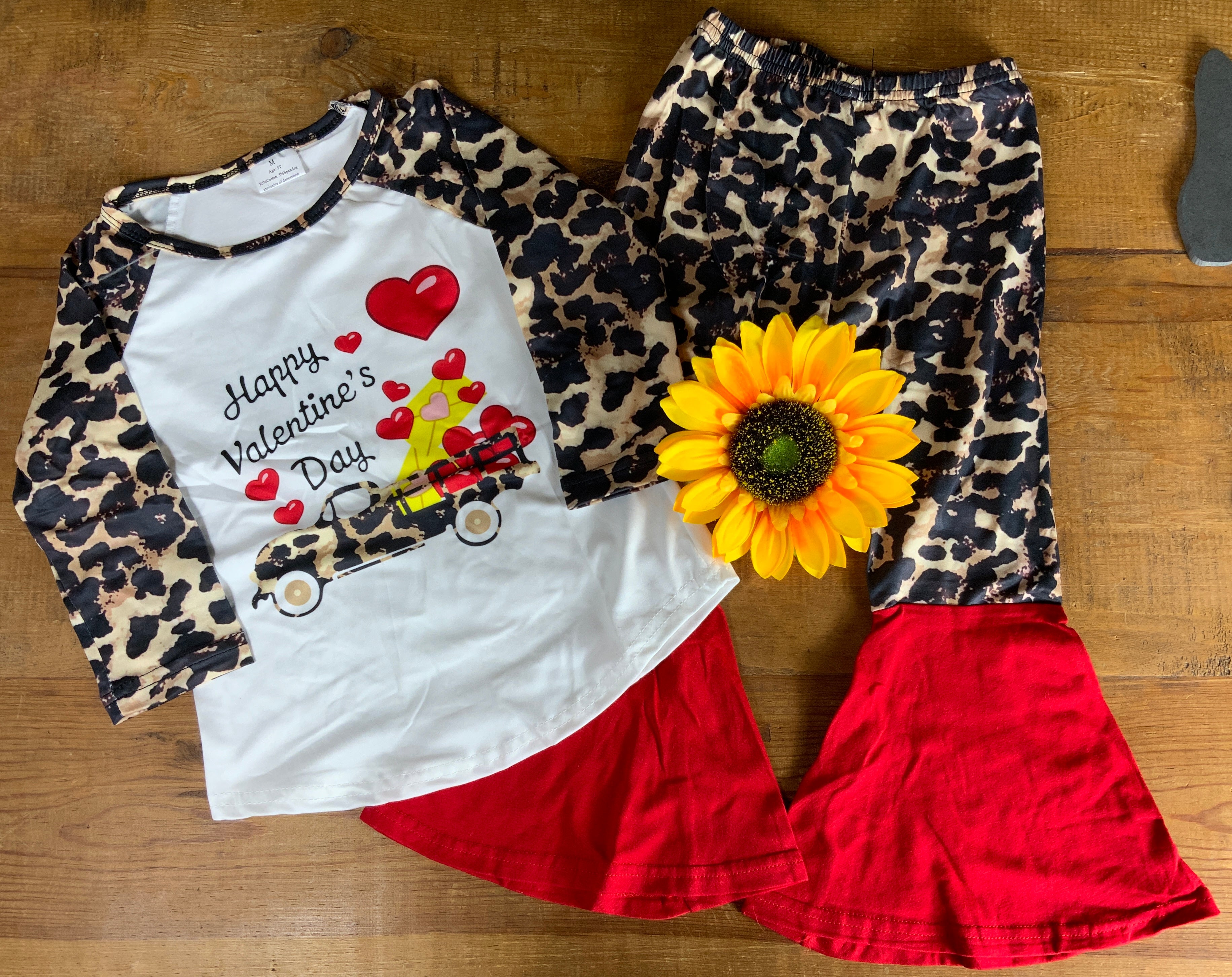 Yawoo Garment brand. Toddler set. White baseball tee with 3/4 leopard sleeves and leopard truck with balloon detail graphic with leopard leggings with red bell bottoms. 4T, 5-6T, 6-7T. $15