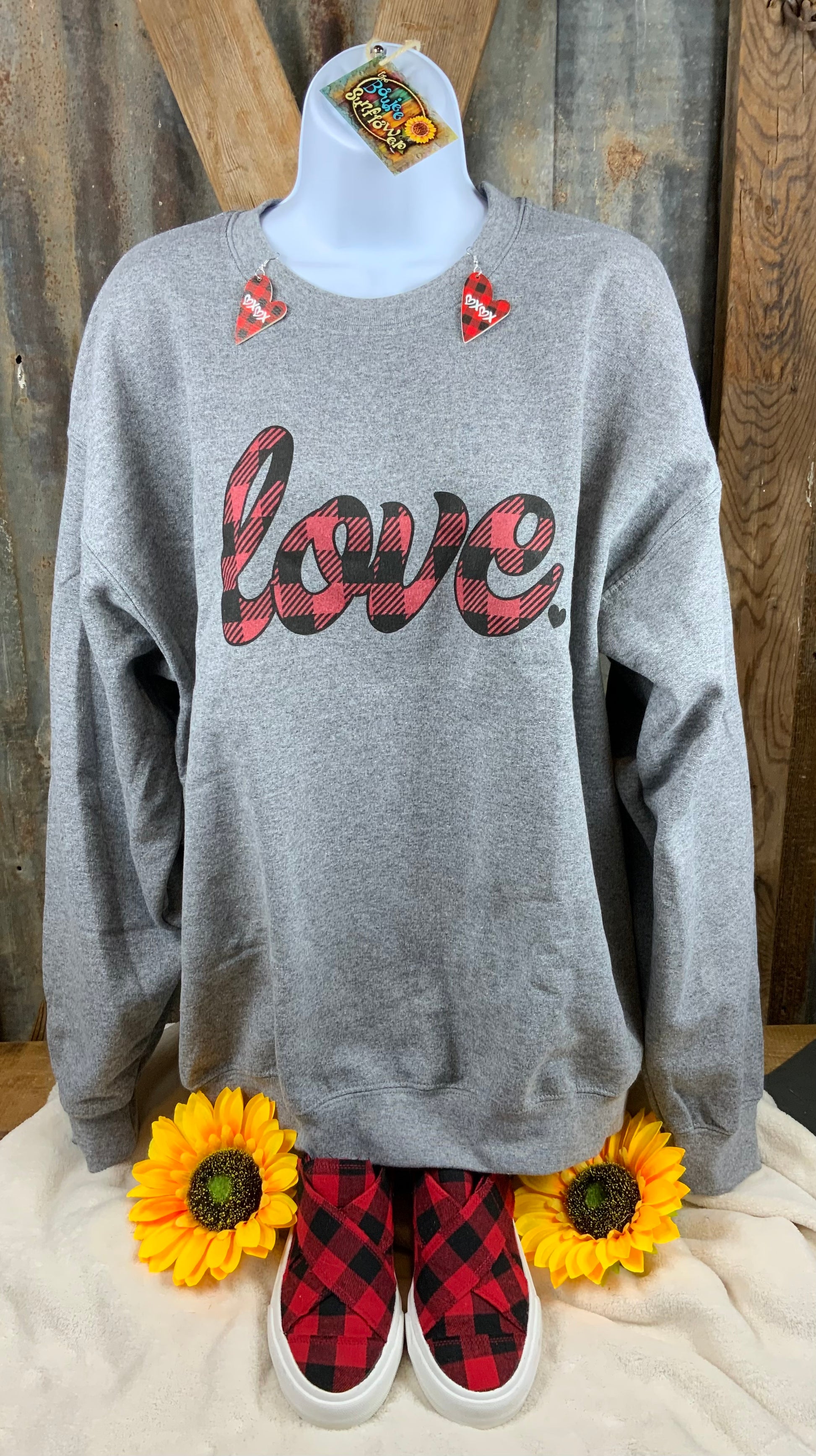 Olive and Ivory brand. Unisex graphite sweatshirt with classic buffalo plaid love design. 50% cotton. 50% polyester. Machine wash. S, M, L, XL $25