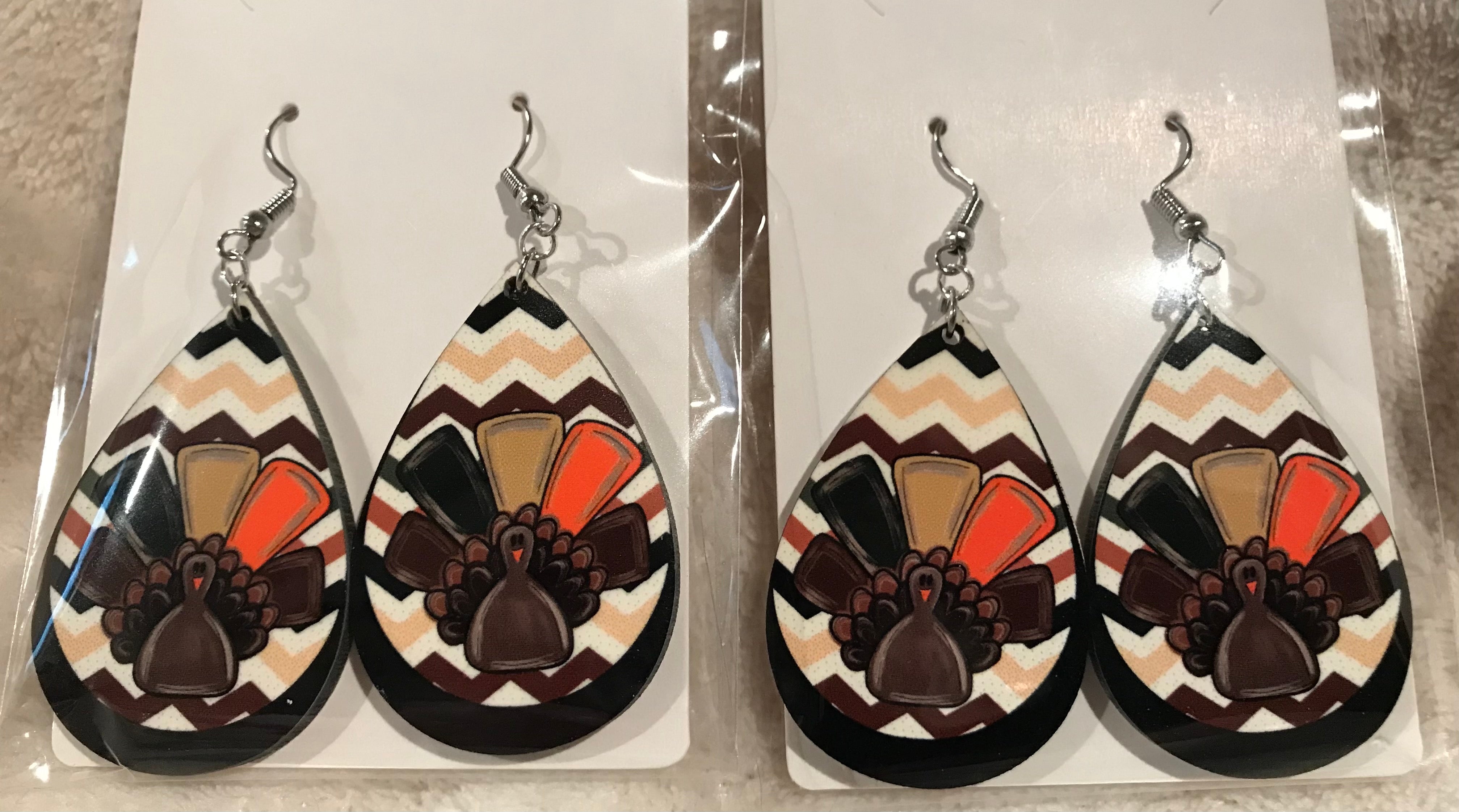 Earring Babe Boutique brand. Made of hard material, 2.5" silver dangle with colorful turkey and chevron designs. $7.25