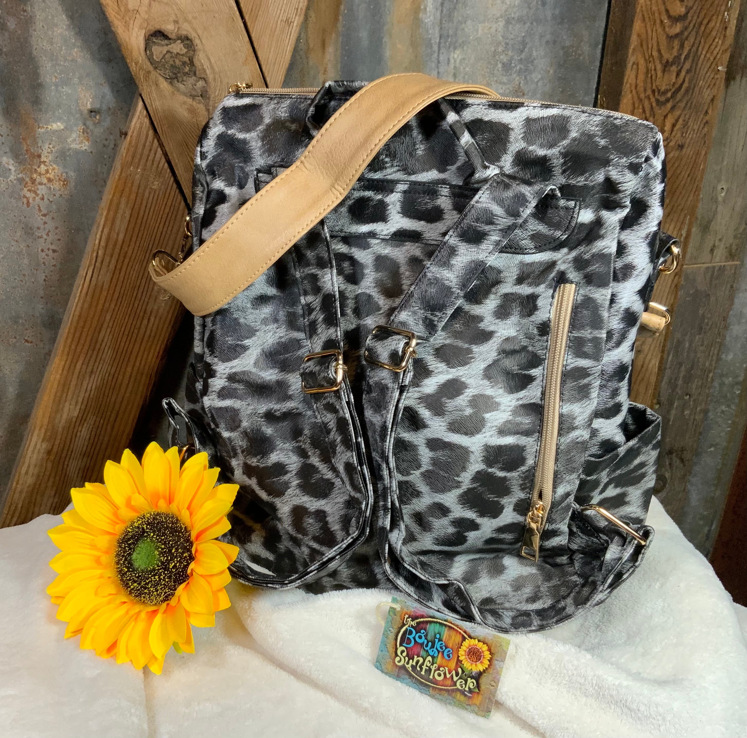 LivFoxy brand. Gray leopard backpack with strap and zippered outer pockets. Tan accented color. Gold hardware. $25