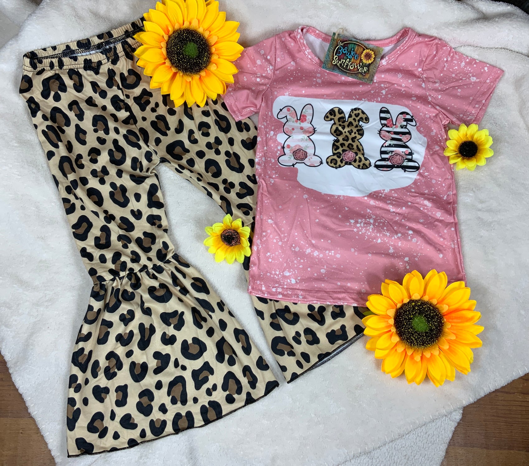 Yawoo Garments brand. Toddler. Soft and stretchy. Top has bleached look detail with 3 colorful print desiged bunnies. The leopard elastic waist pants have bell bottoms. Sizes: 2T, 3T, 4T. $18